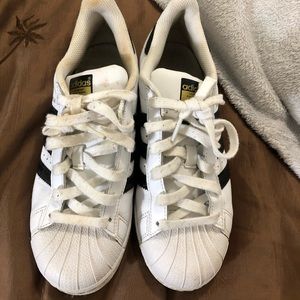 A pair of gently worn black and white Adidas